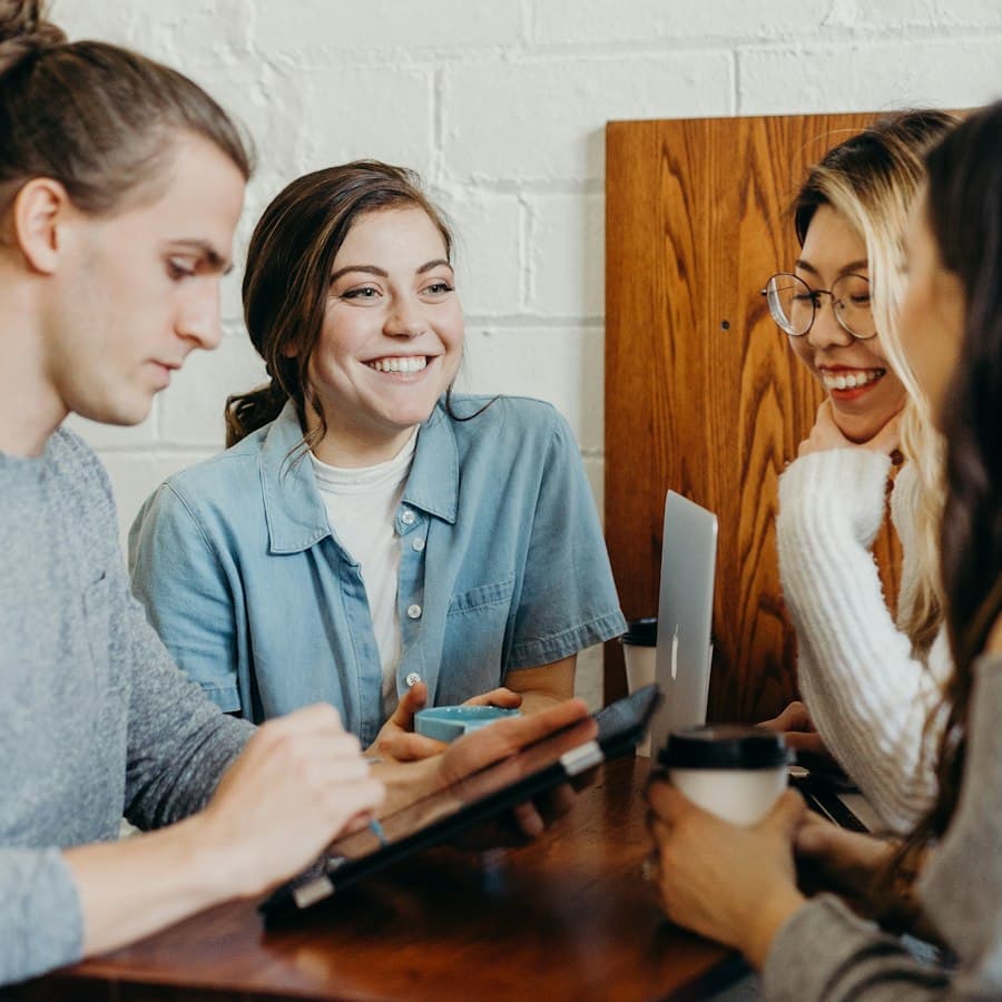 A young team smiling while working together at a table